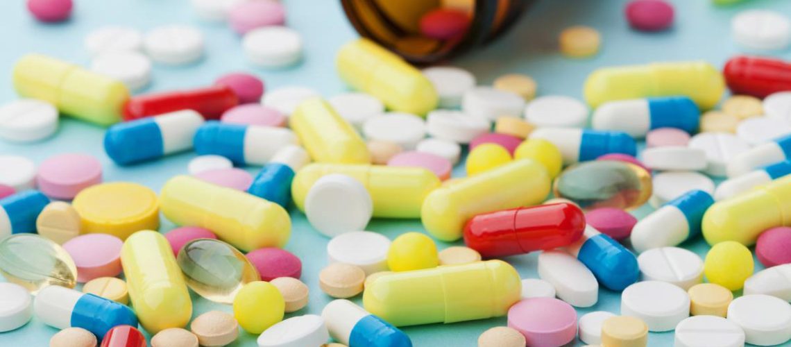 Colorful-Drug-Pills-Blue-Background-Pharmaceutical.jpg