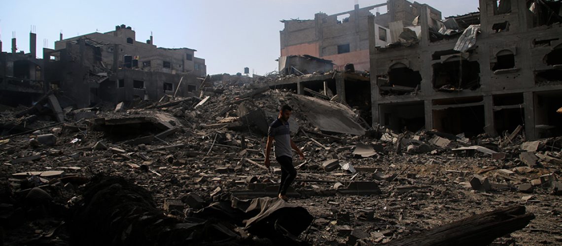 Gaza-Palestine-Man-Walks-Through-Rubble.jpg