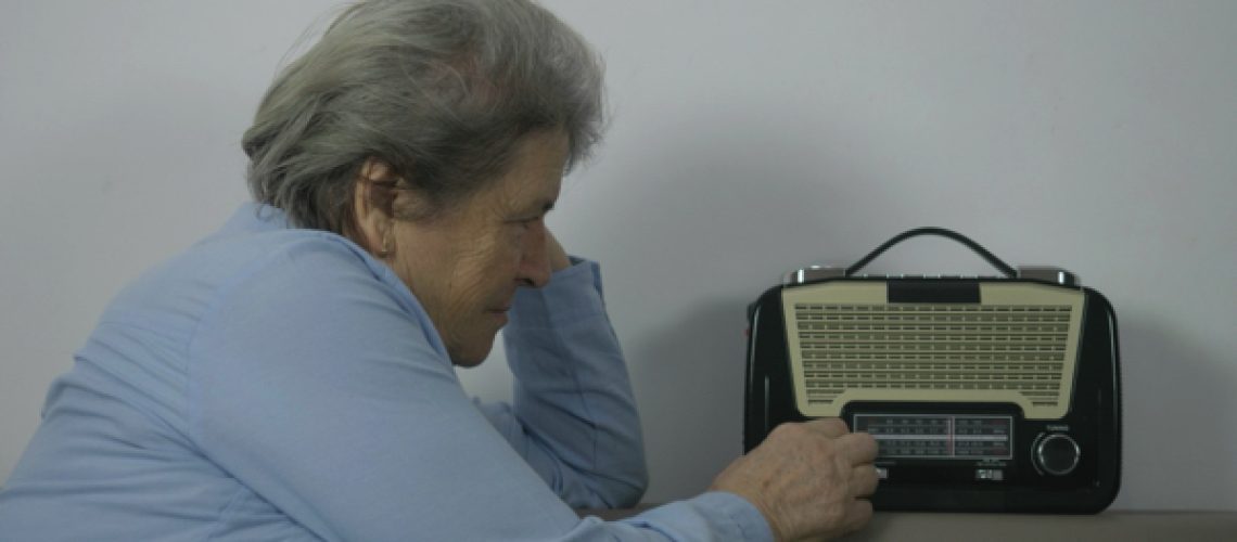 Old-woman-searching-favorite-station-on-retro-radio-1.jpg