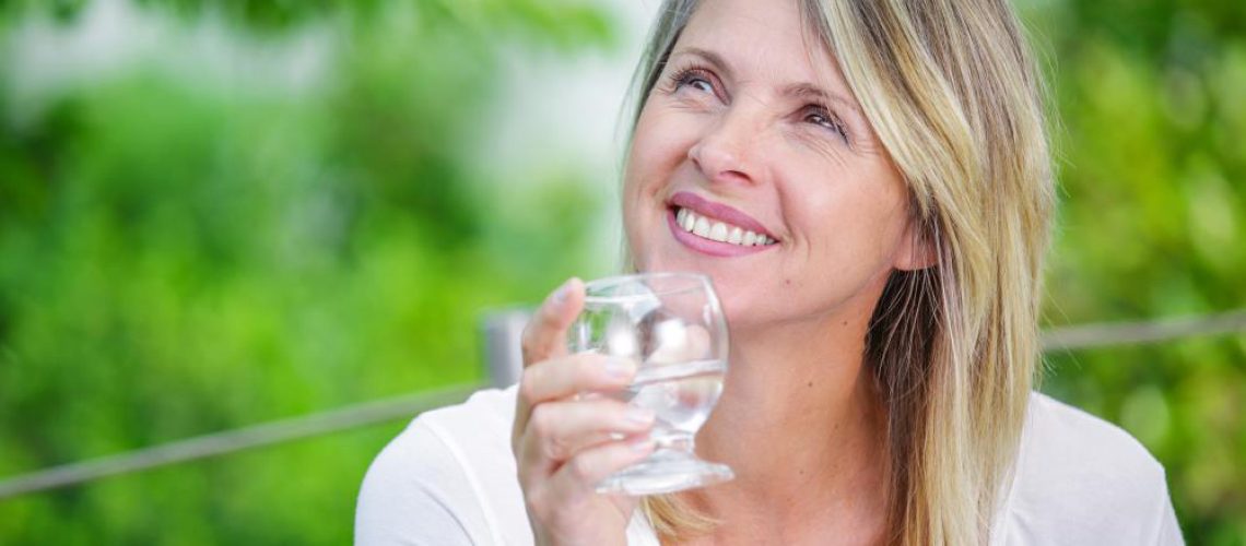 Water-Woman-Middle-Drinking-Glass-Heat-Hydrate.jpg
