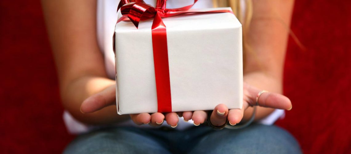 Woman-Holding-Present-Red-Ribbon-Gift.jpg