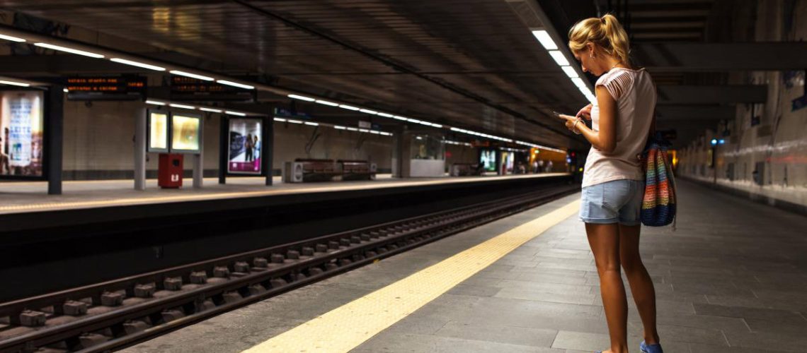 Woman-Waiting-Subway-Train-Station-Phone.jpg