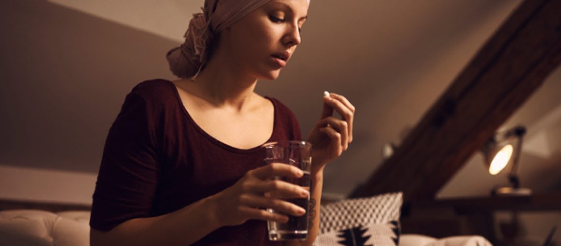 Woman-suffering-from-cancer-taking-medicine-1.jpg